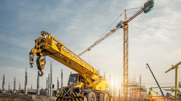 Mobile Crane on a road and tower crane in construction site